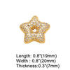 A gold-toned crystal heart cross pendant shaped like a five-pointed star.