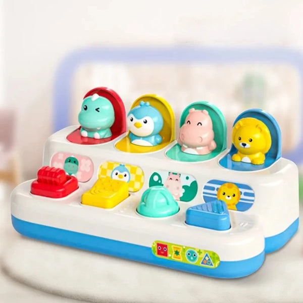 A white interactive pop-up sensory toy featuring various animal figures in colorful compartments.