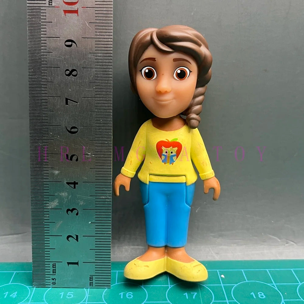 A playful cartoon PVC figurine of a girl with brown hair, wearing a yellow shirt and blue pants.