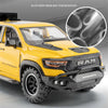 Yellow RAM TRX diecast pickup truck model with black accents and off-road tires