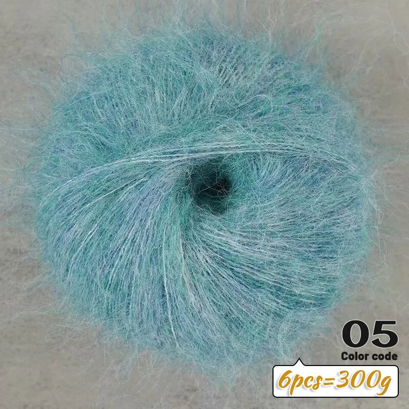 A close-up view of light blue long-haired alpaca blend yarn with a dark center, labeled as color code 05.