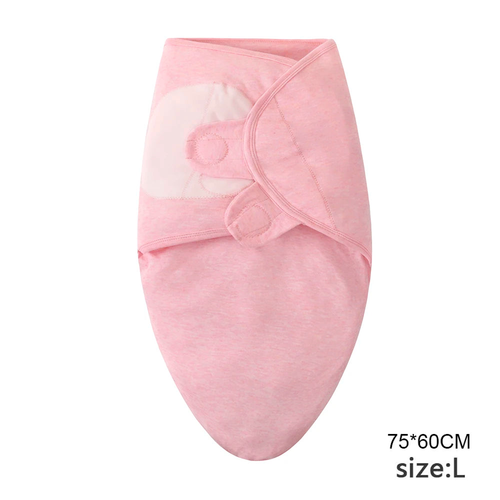 Pink cotton newborn swaddle blanket and hat set with a visible fabric detail