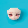 A pale pink, stylized doll face with large pink eyes and subtle blush against a bright blue background.