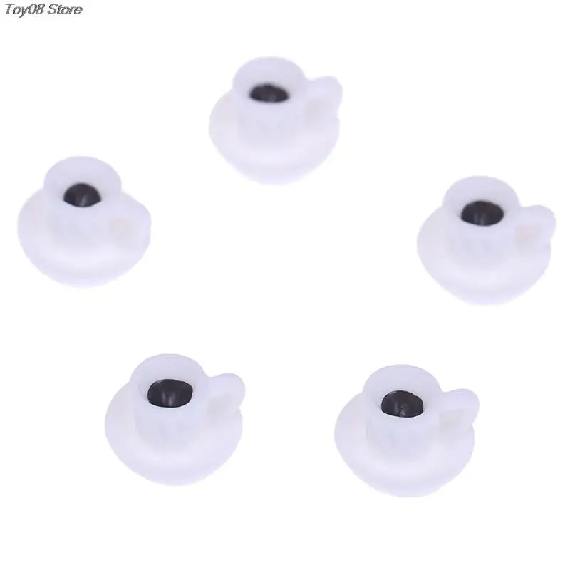 A set of five small white resin coffee cups for dollhouse kitchens