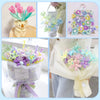 A collection of colorful chenille stem craft sticks in various shades of purple, pink, and green arranged in bouquets.