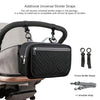 Black portable diaper bag organizer with zippers and straps shown attached to a stroller frame.