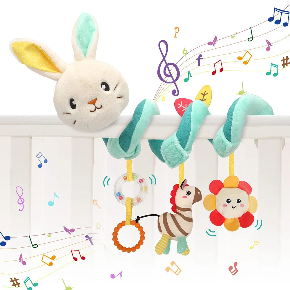 A fluffy white rabbit sensory toy with blue ears hangs from a white railing, surrounded by musical notes.