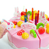 A pink pretend play birthday cake set featuring colorful candies, candles, and decorative elements for children.