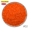 A pile of 5mm orange beads, packaged in a circular display, for craft projects.