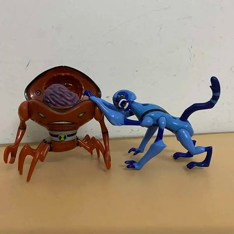A Ben 10 Omnitrix Projector Watch toy featuring two alien figures, one orange and one blue.