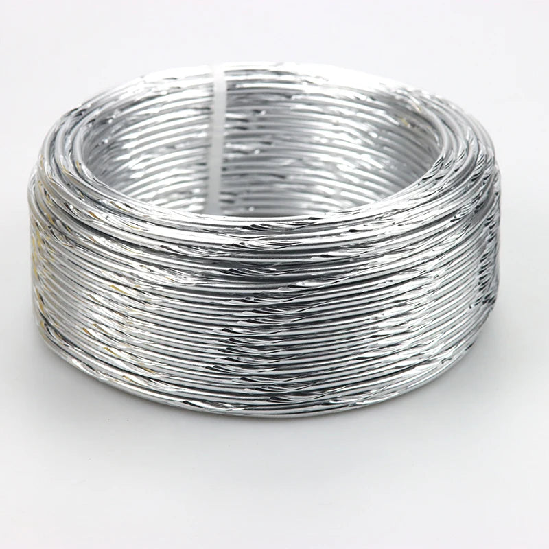Silver flexible aluminum craft wire coiled into a circular ring for jewelry making