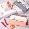 A package of OUMMAA air dry clay is shown next to a pink cake and a small decorative figure.