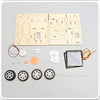 A wooden model kit for a solar-powered lunar rover featuring circuit boards, components, and wheels.