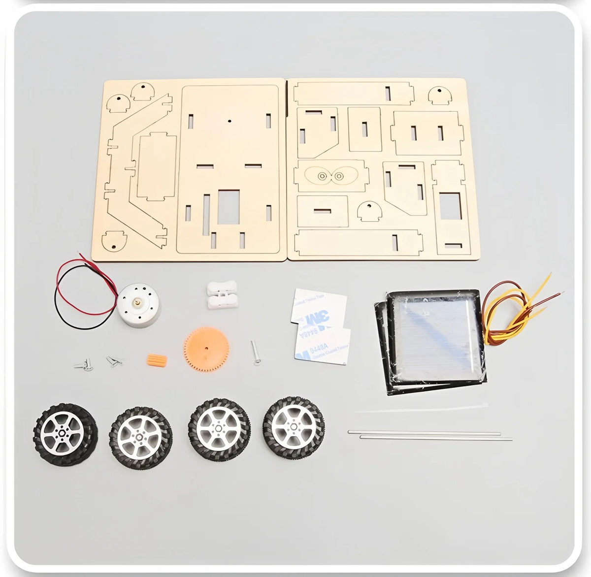 A wooden model kit for a solar-powered lunar rover featuring circuit boards, components, and wheels.