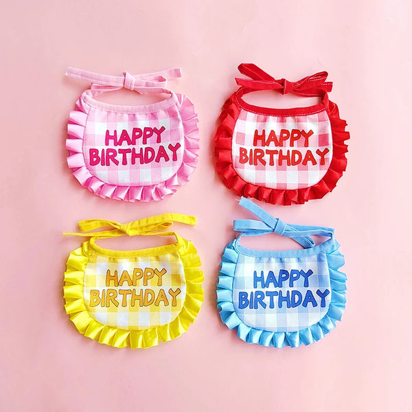 A set of four fabric birthday hats and bibs in pink, red, yellow, and blue gingham patterns.