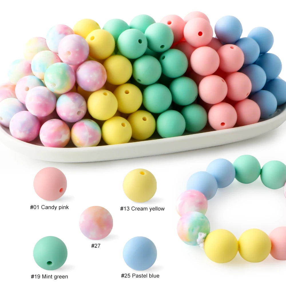 A collection of soft food-grade silicone beads in various pastel colors including pink, yellow, green, and blue.