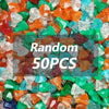 A pile of colorful, translucent building block treasure chest pieces in various shades of orange, green, and clear.