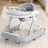 A gray 2-in-1 toddler push walker with a padded feeding tray is shown on a light-colored floor.