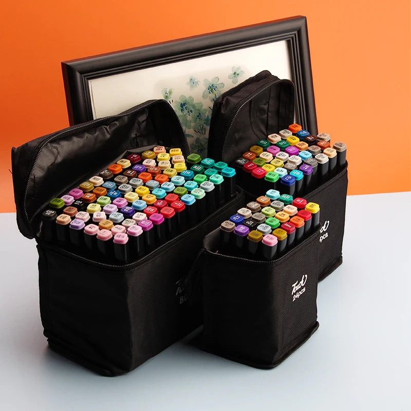 A black storage box with two open compartments filled with alcohol art markers in various colors.