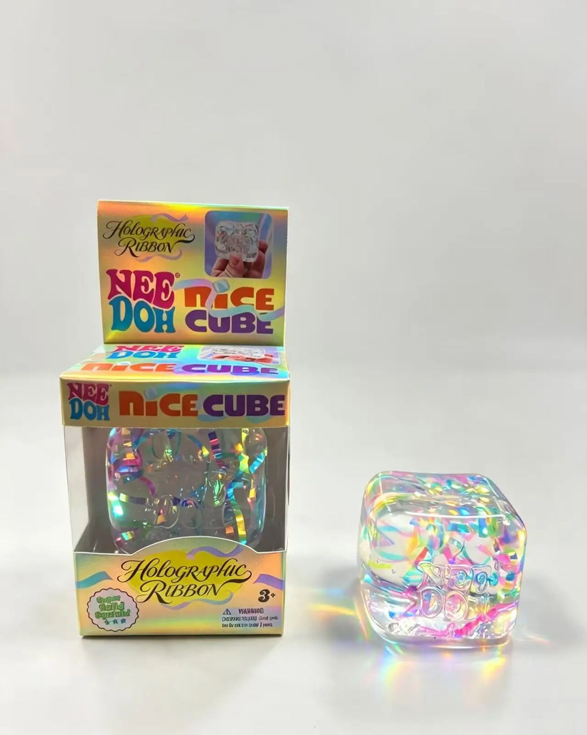 A box and a clear cube of holographic ribbon fidget toy for stress relief and sensory play.