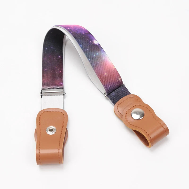 A kids canvas belt with elastic stretch featuring a purple and pink galaxy print on the strap.