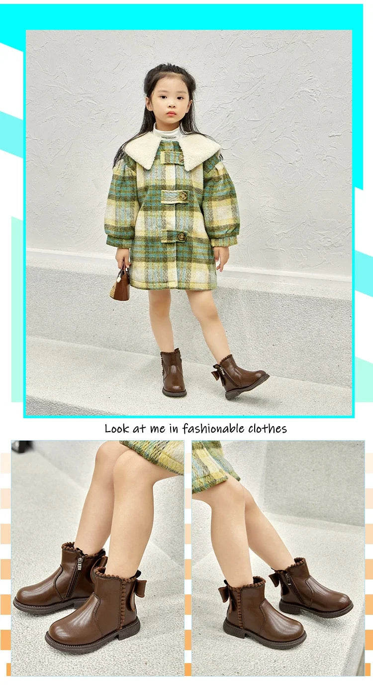 A young girl models a plaid coat with a cream collar and ankle boots.