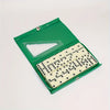 A green domino box with a clear window showing a set of white and black domino tiles.