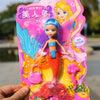 A pink and yellow mermaid princess doll with blue hair and orange tail is held in a hand.