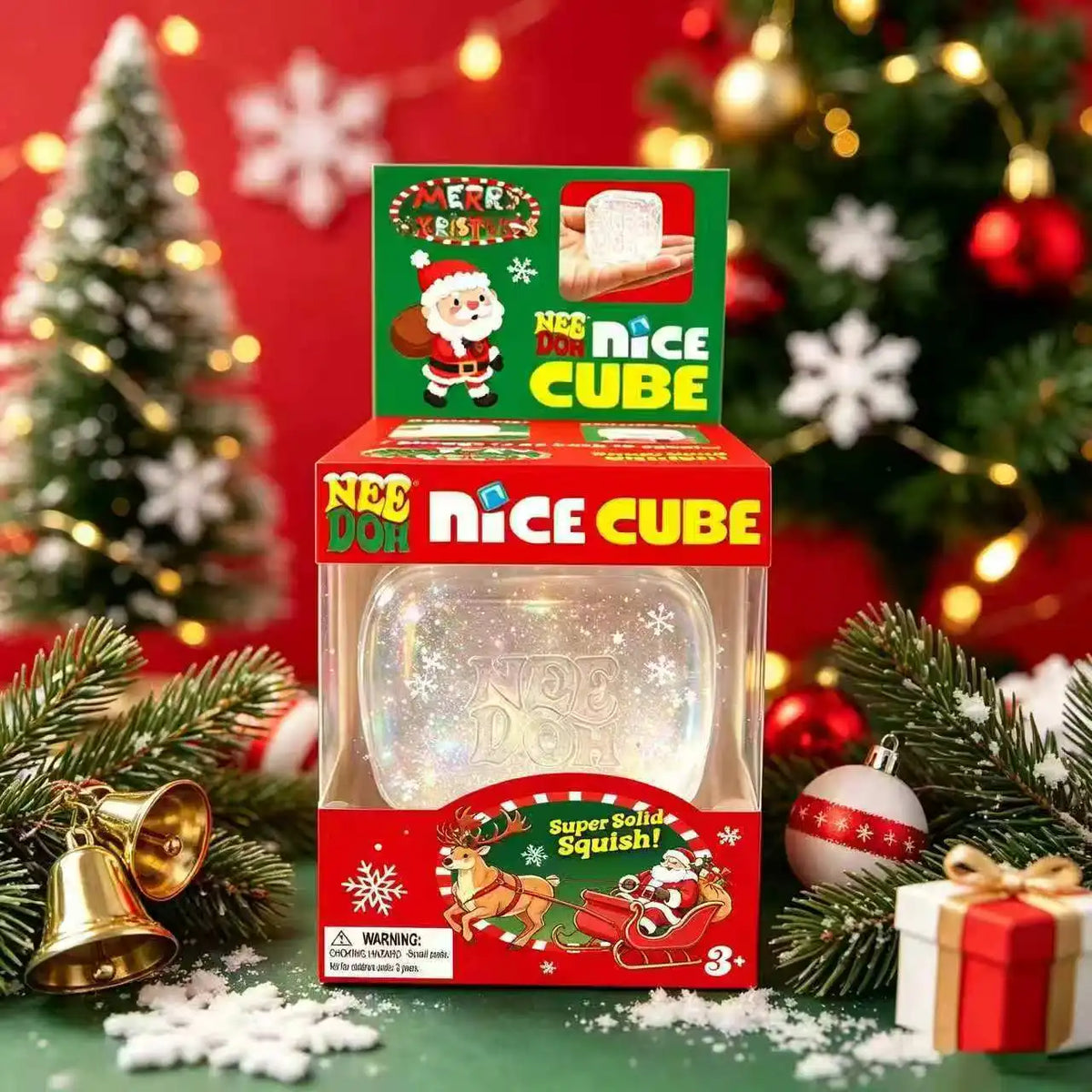 A box of Nee Doh Nice Cube squishy fidget toy with festive Christmas decorations and greenery.