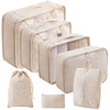A set of beige travel packing cubes and a storage bag for organizing items.