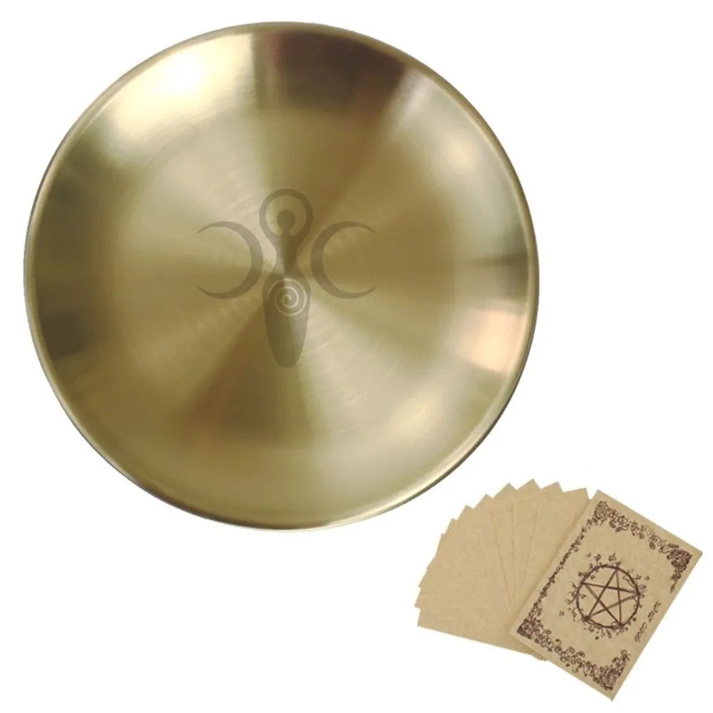 A round, brass-colored altar plate with a pentagram design and several ritual parchments.