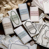 A collection of vintage scrapbook paper and cardstock sheets featuring various patterns, including birds, ribbons, and geomet