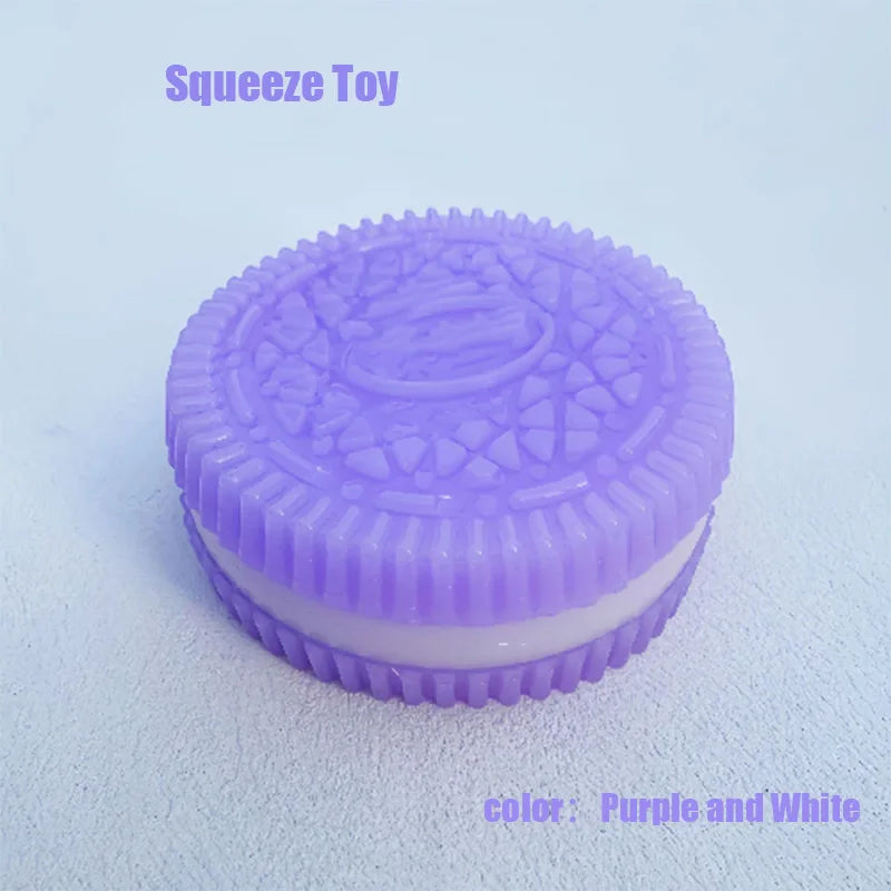 A purple and white biscuit-shaped squeeze toy with a textured top and smooth bottom.