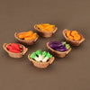 A set of miniature dollhouse vegetable baskets filled with various colorful vegetables like carrots, tomatoes, and peppers.