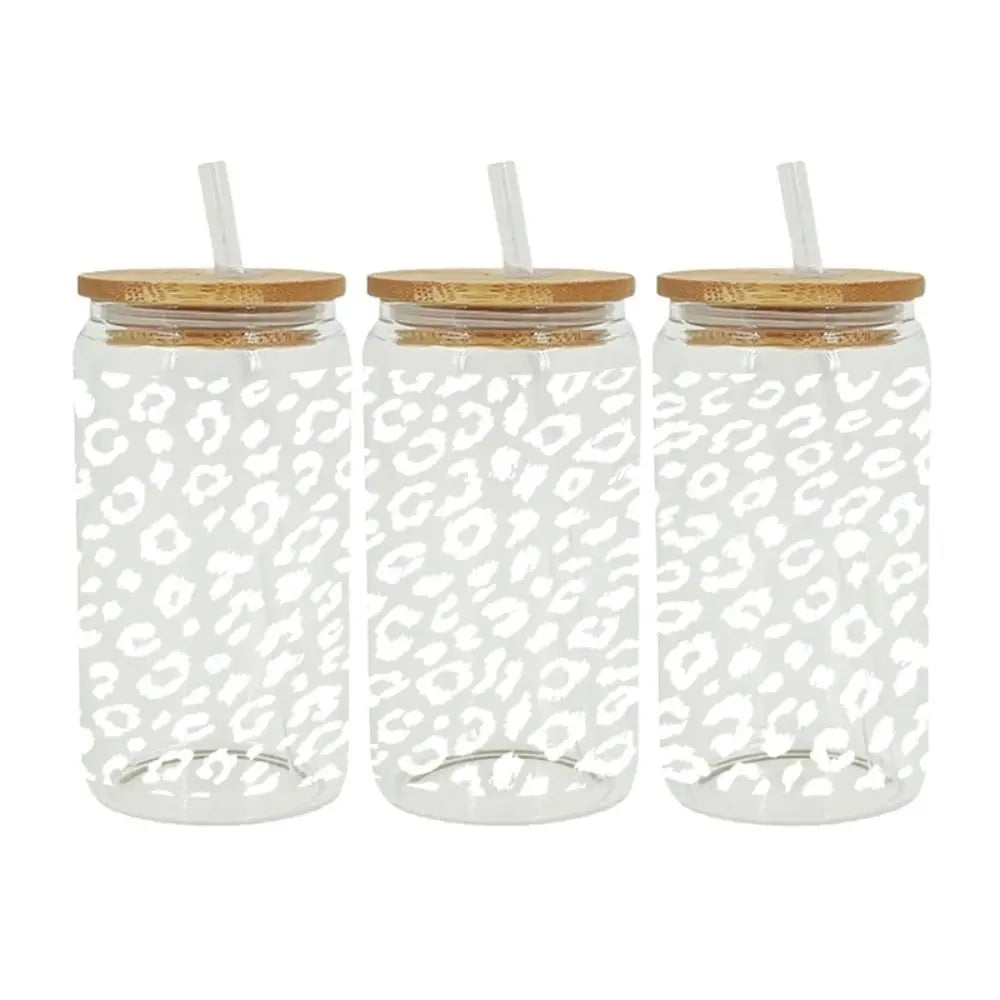 Three clear glass cups wrapped with leopard print UV DTF transfer stickers and cork lids