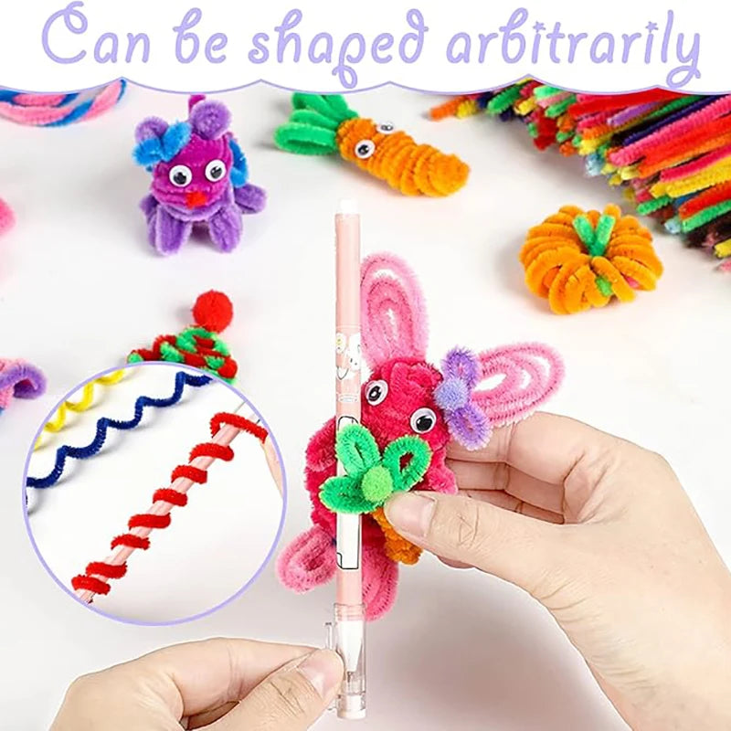 A hand holds a pink chenille stem craft set featuring colorful, arbitrarily shaped stems like a purple monster and an orange 