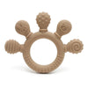 A silicone baby teether shaped like a ring with small beads and animal-like protrusions in a beige color.