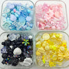 Clear containers filled with various mixed acrylic loose beads in shades of blue, pink, and yellow for jewelry making