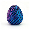 A close-up of a textured, iridescent blue dragon egg fidget spinner with a spiky surface.