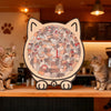 A wooden cat-shaped jigsaw puzzle featuring a crowd of cats in various colors displayed on a wooden shelf.