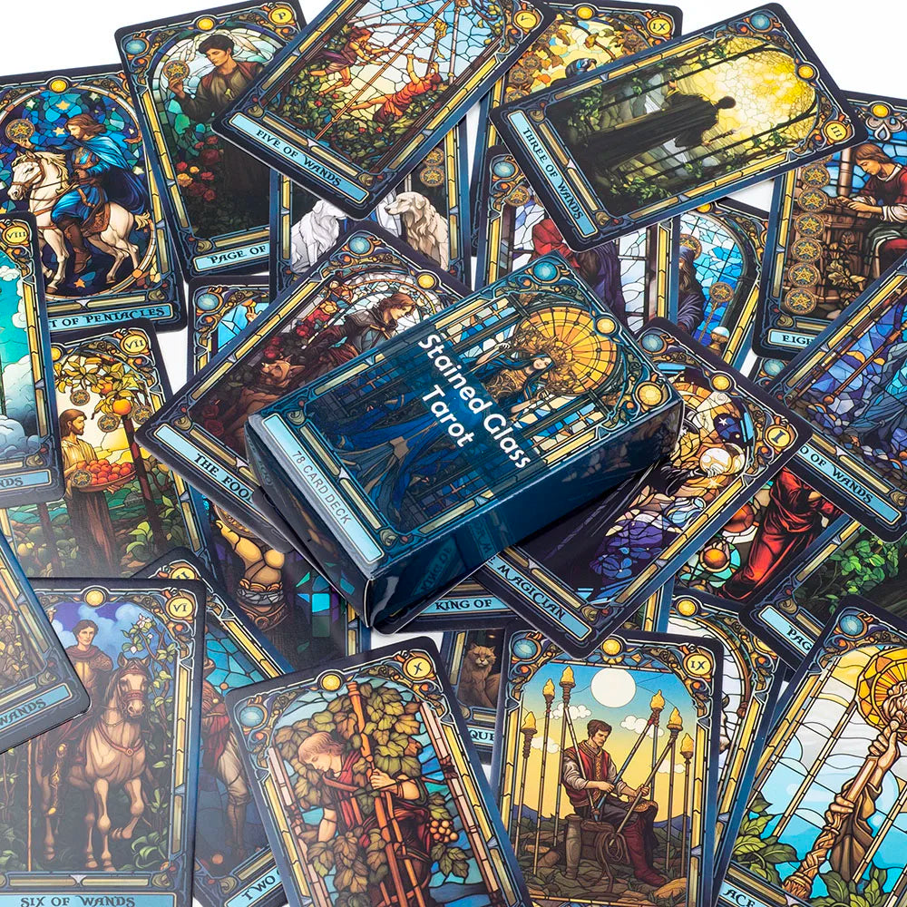 A collection of Stained Glass Tarot cards and a box set displayed on a surface.