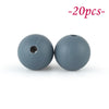 Two round, smooth gray silicone beads are shown against a white background.