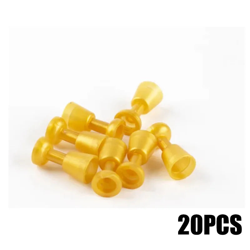 A pile of 20 small, gold-colored building block coins.