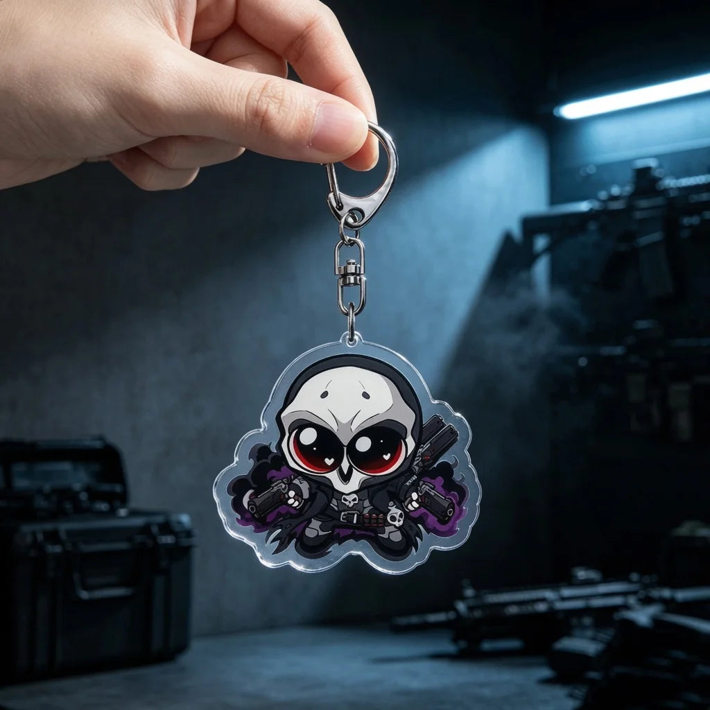A hand holds an anime-inspired acrylic keychain charm featuring a skull and guns against a dark background.