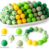 A collection of soft food-grade silicone beads in various shades of green and yellow for DIY jewelry and crafts.