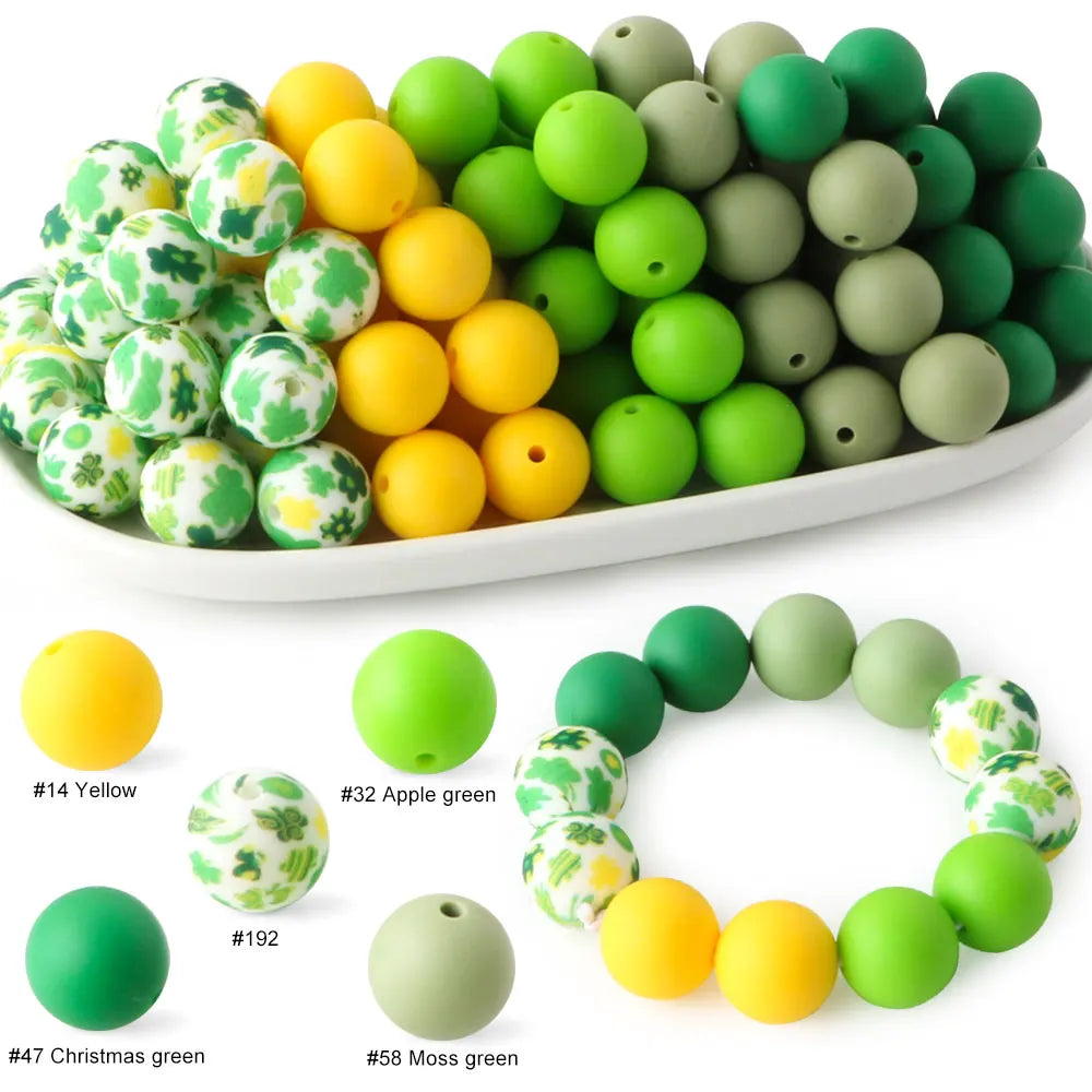 A collection of soft food-grade silicone beads in various shades of green and yellow for DIY jewelry and crafts.