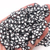 A pile of black and white polymer clay slices assorted for DIY crafts