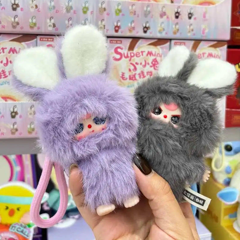 A hand holds a fluffy purple bunny collectible from the Baby Three Super Mini Bunny Series blind box.