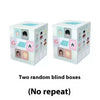 Two random blind boxes of Alien Stage Baby Series collectible keycaps in light blue and white packaging.