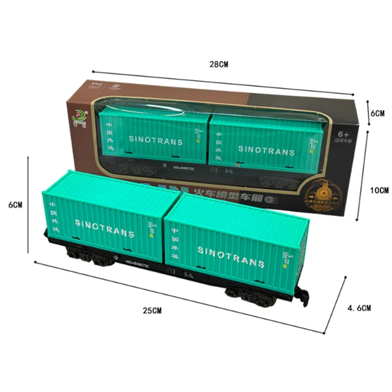 A model vintage steam train set in a cardboard box with green locomotive and carriages.